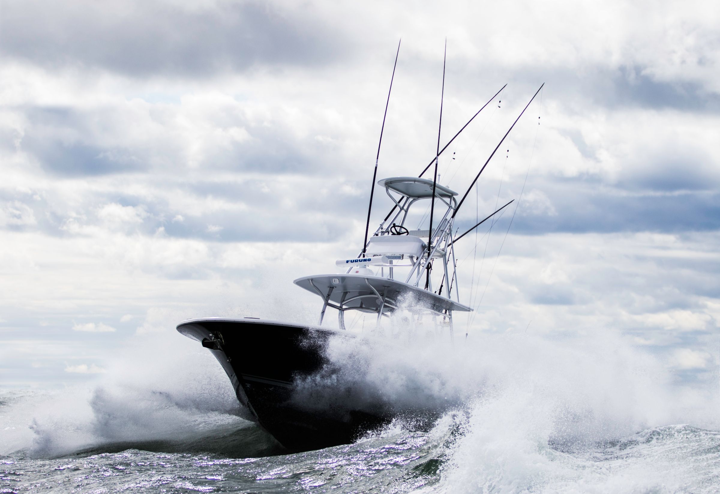 Sport fishing boat running offshore through open water
