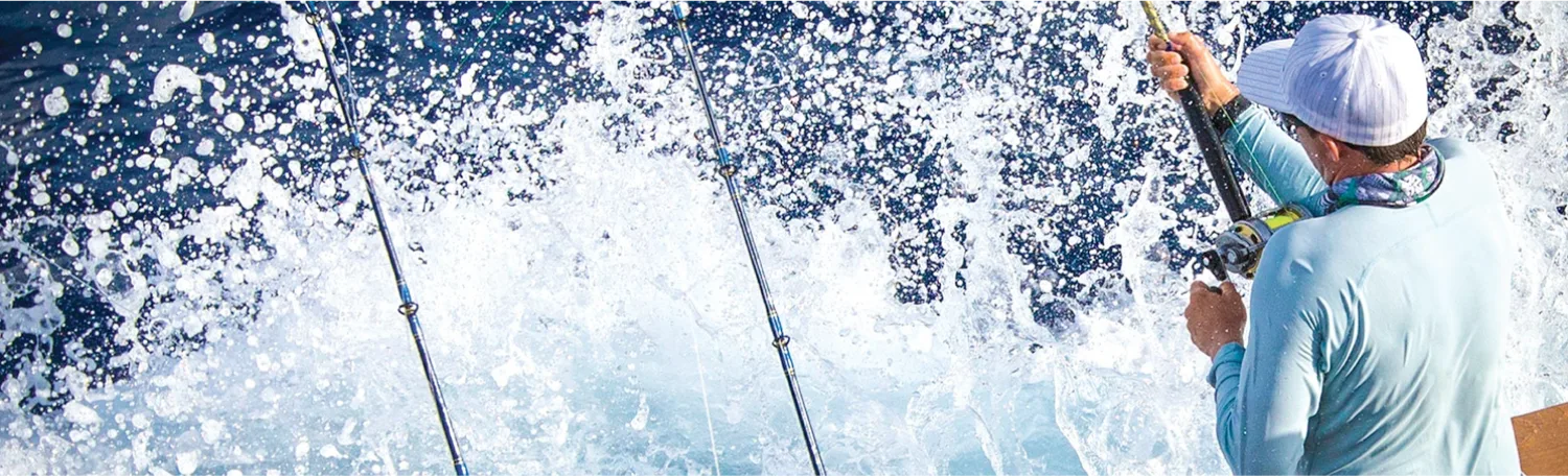Angler fishing from a boat with water splashing