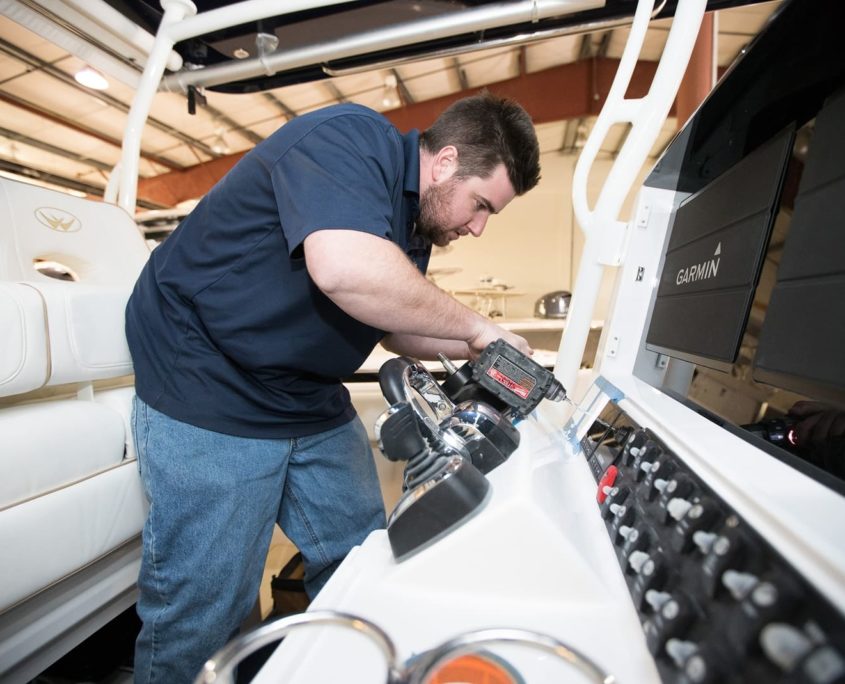 Navtronics employee working on navigation system on boat